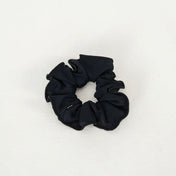 The Scrunchies 2 Pack, featuring black fabric scrunchies ideal for ballet hair ties or dancer accessories, is displayed on a plain white surface.