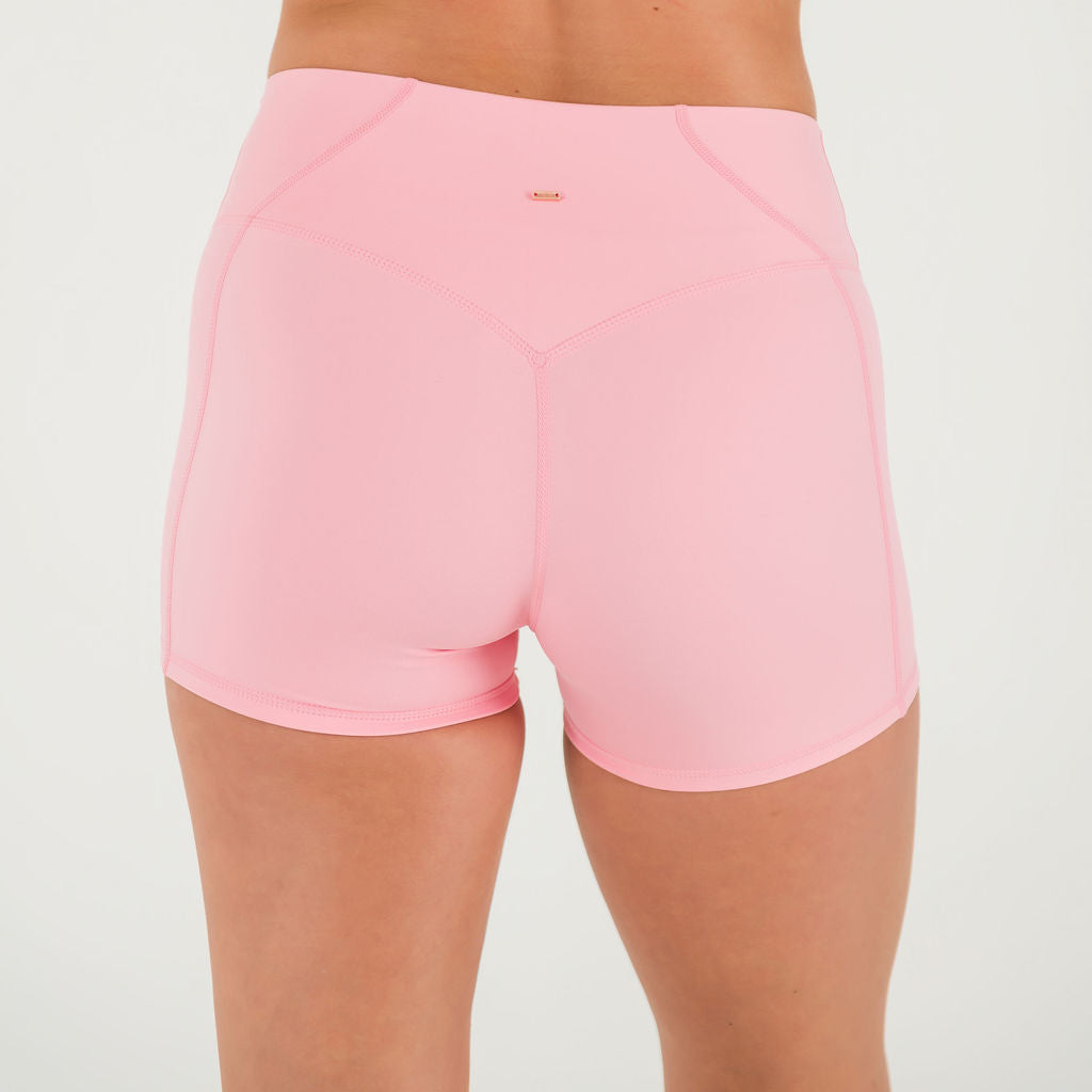 A person is shown from the back against a plain white background wearing Bonbon Vivid Pink Shorts, made from soft, stretchy fabric with visible seams and a fitted design.