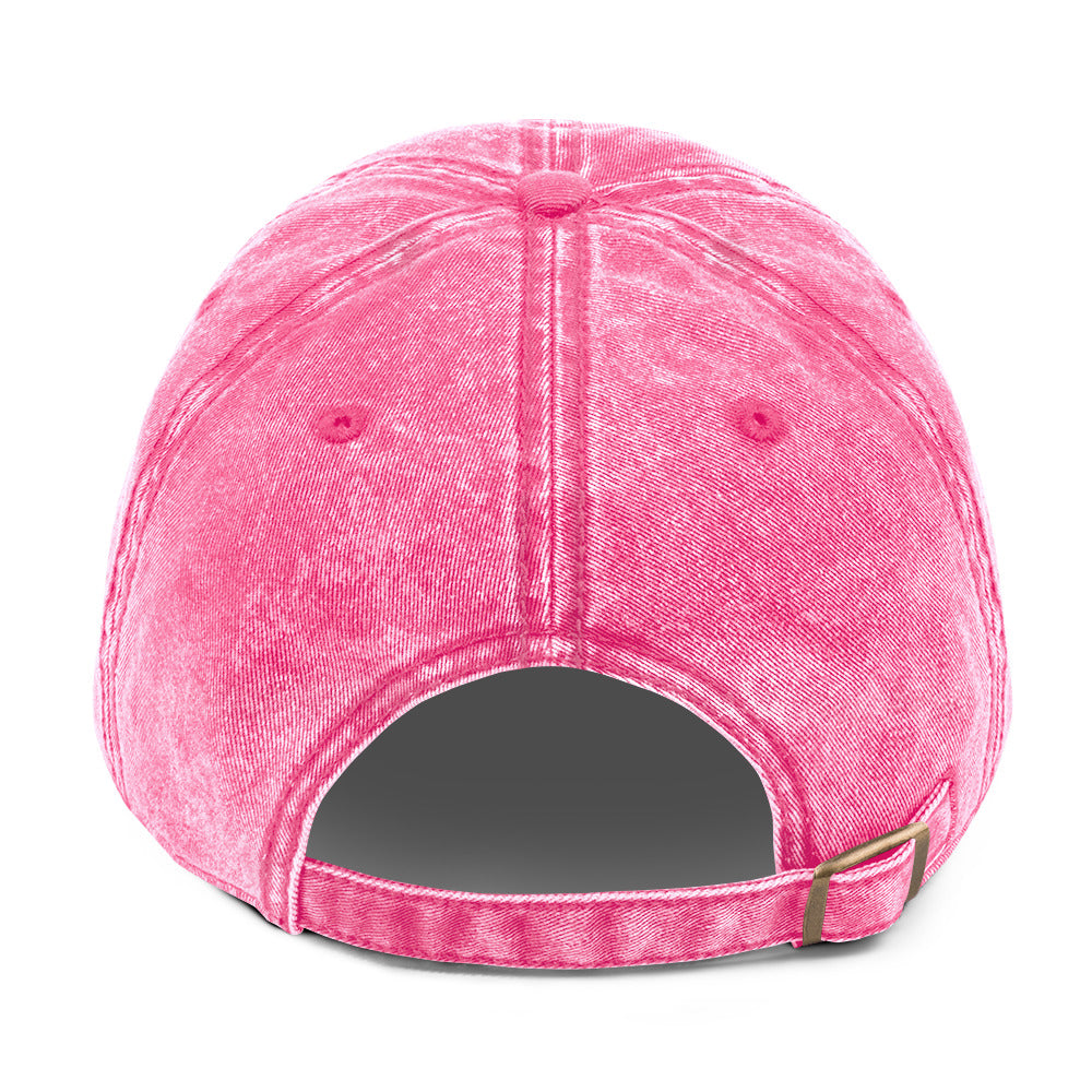 Back view of the Vintage Cap - Girly Pink: features distressed pink cotton twill, visible stitching, two eyelets, and an adjustable strap with an antique brass buckle.